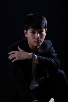 Portrait of Asian young man on black background