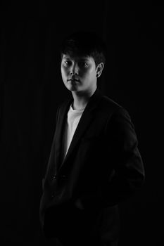 Portrait of Asian young man on black background