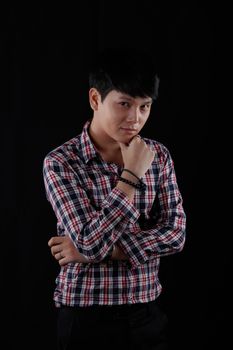 Portrait of Asian young man on black background