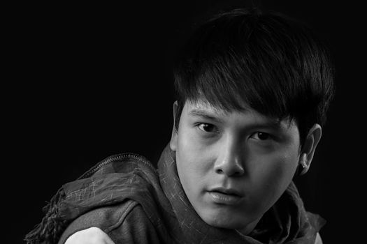 Portrait of Asian young man on black background