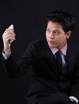 Portrait of Asian young man on black background