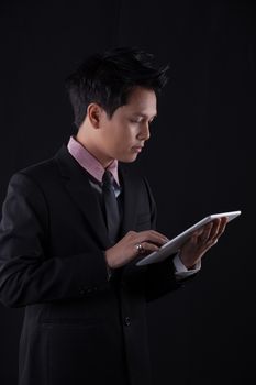 Portrait of Asian young man on black background