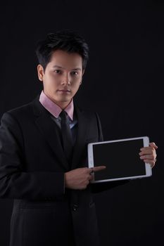 Portrait of Asian young man on black background