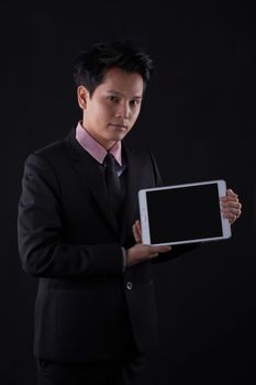 Portrait of Asian young man on black background