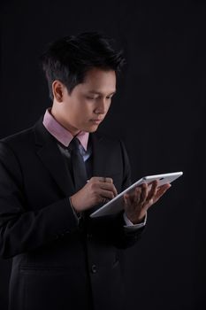 Portrait of Asian young man on black background