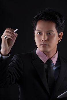 Portrait of Asian young man on black background