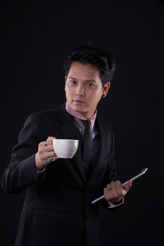 Portrait of Asian young man on black background