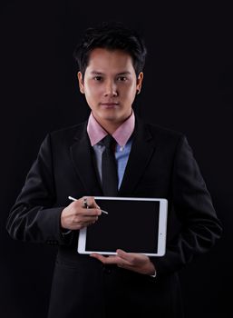 Portrait of Asian young man on black background