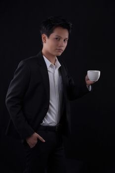 Portrait of Asian young man on black background