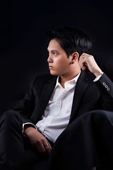 Portrait of Asian young man on black background