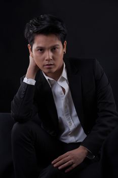 Portrait of Asian young man on black background