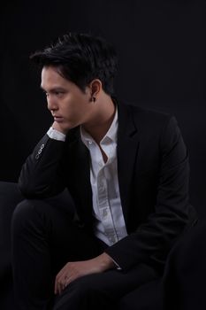 Portrait of Asian young man on black background