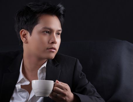 Portrait of Asian young man on black background