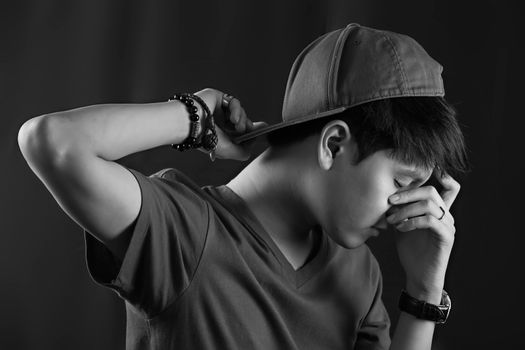 Portrait of Asian young man on black background