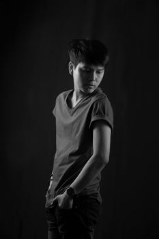 Portrait of Asian young man on black background