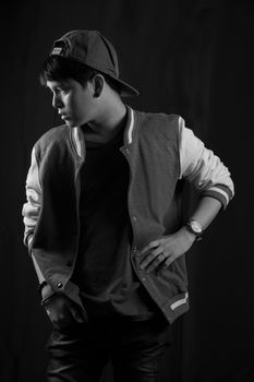 Portrait of Asian young man on black background