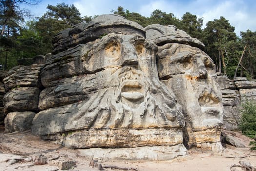 Heads of Devils are about 9 m high rock sculptures of giant heads carved into the sandstone cliffs in the pine forest above the village Zelizy in the district Melnik, Czech republic. It is the work of sculptor Vaclav Levy, who created in the period 1841-1846.