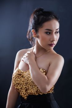 Portrait of beautiful Asian young girl on black background