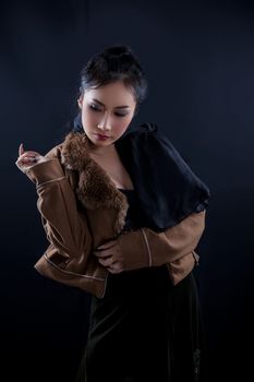 Portrait of beautiful Asian young girl on black background