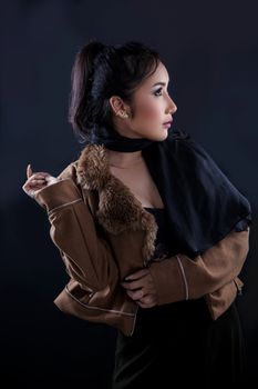 Portrait of beautiful Asian young girl on black background