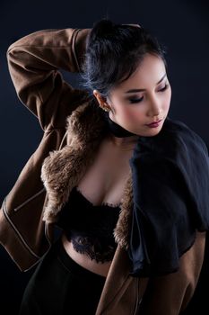Portrait of beautiful Asian young girl on black background