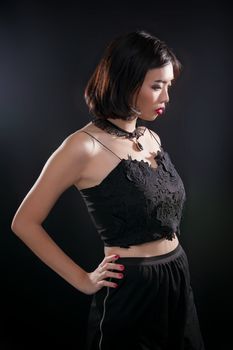 Portrait of beautiful Thai young girl on black background