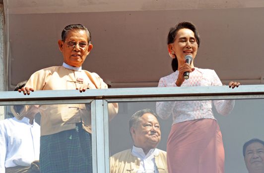 MYANMAR, Yangon: Myanmar opposition leader Aung San Suu Kyi (R), flanked by party patron Tin Oo (L) delivers a speech from the balcony of the National League of Democracy (NLD) headquarters in Yangon on November 9, 2015. Aung San Suu Kyi's opposition party November 9 said they are on course to claim more than 70 percent of seats after Myanmar's poll, a gain that could bring a major power shift from the military. 