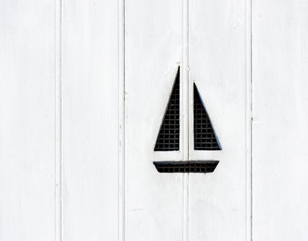 Sail boat on white wooden shutter