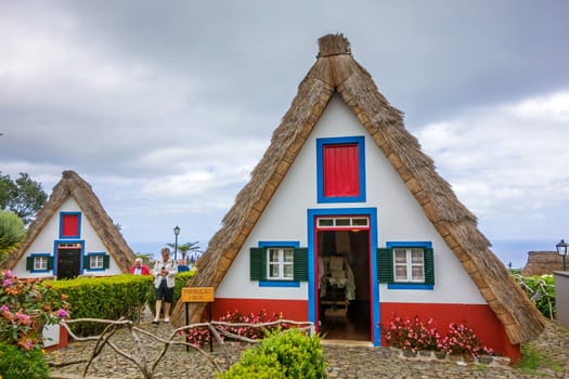 Santana, Portugal - June 7, 2013: Flower's related craft souvenir shop built like a typical triangular house, Island of Madeira.