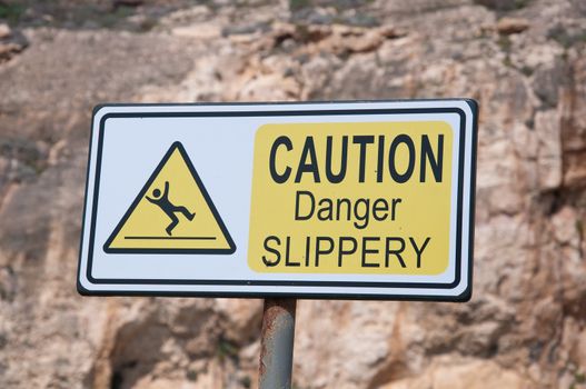 Sign indicating attention danger of slipping