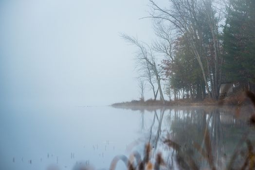 Still, cool air and warm lake water make for an early morning masking of the water in a near opaque fog show.