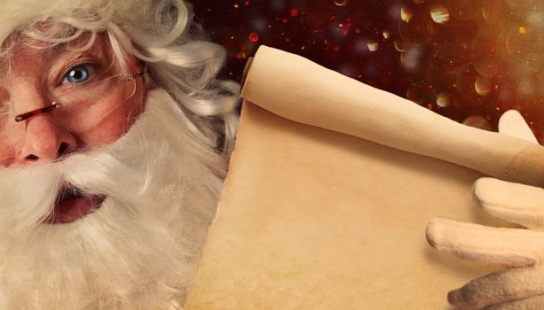 Closeup of Santa Claus holding a Santa List scroll 
