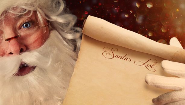Closeup of Santa Claus holding a Santa List scroll 