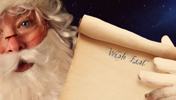 Closeup of Santa Clause holding wish list scroll 