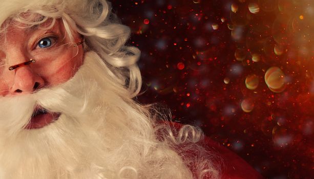 Closeup of Santa Claus with a magical holiday background