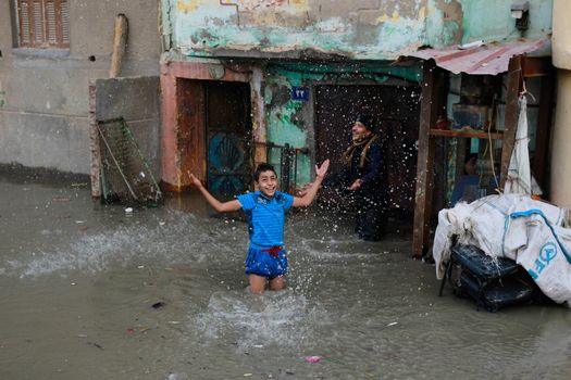 EGYPT, Alexandria: People are seen in the flooding road after a torrential rain caused flood in the Kafr El Arab neigborhood in west of Alexandria, Egypt on November 07, 2015.