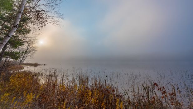 Still, cool air and warm lake water make for an early morning masking of the water in a near opaque fog show.