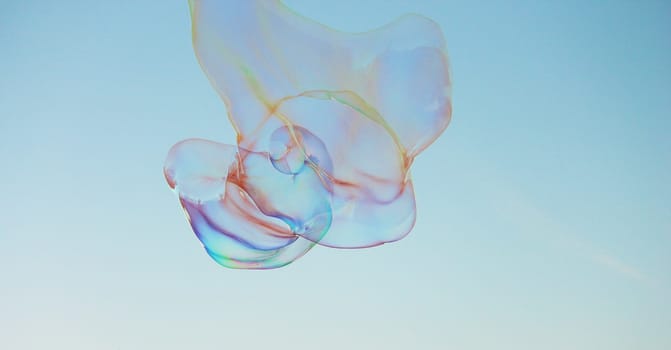 Soap bubbles on a blue sky illuminated by the sun texture background with copyspace