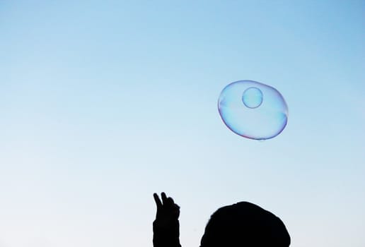 Soap bubbles on a blue sky illuminated by the sun texture background with copyspace