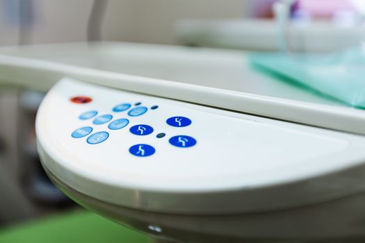 Close-up of the control panel with buttons on the dental chair