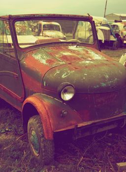 Grunge Old Truck on Others Old and Broken Cars background Outdoors. Retro Styled