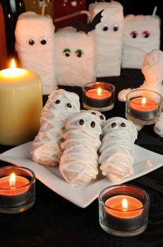 honey-cake white glaze in the form of a mummy on table Halloween