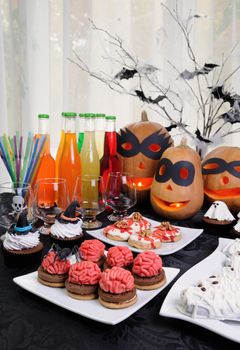 Table served with a variety of sweets and drinks on Halloween