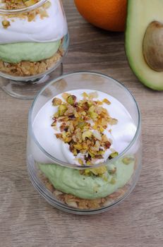 Multi-layered parfait with avocado and cream in nuts