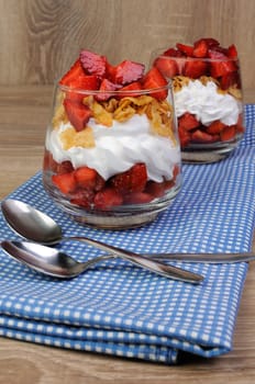 Dessert of strawberries with whipped cream and corn flakes