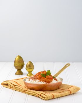 Indian butter chicken served on top of white rice.