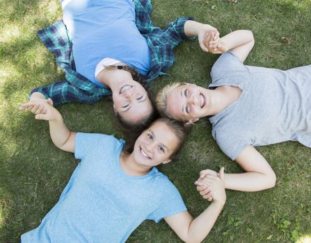 Three Girls Lying on The Green Grass