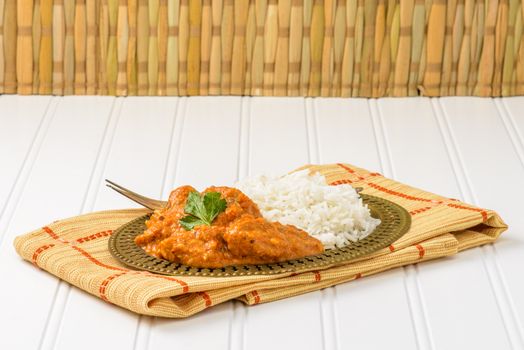 Plate of Indian chicken korma served with basmati rice.