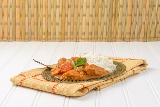 Plate of Indian chicken korma served with basmati rice.