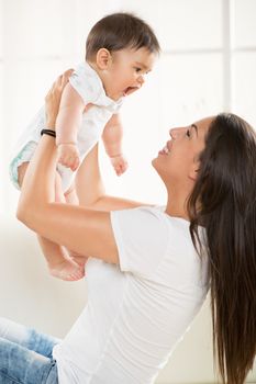 Mother and baby playing at home